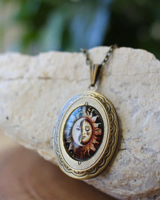 Vintage-style locket with sun and moon design