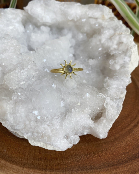 Gold ring with a gemstone on a white crystal rock