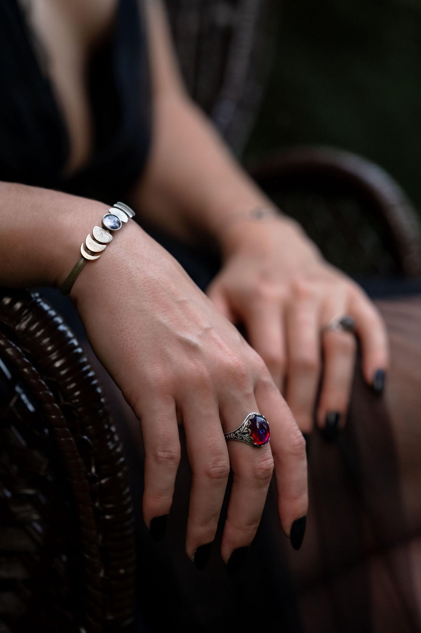 Close-up of hands with jewelry on a dark background