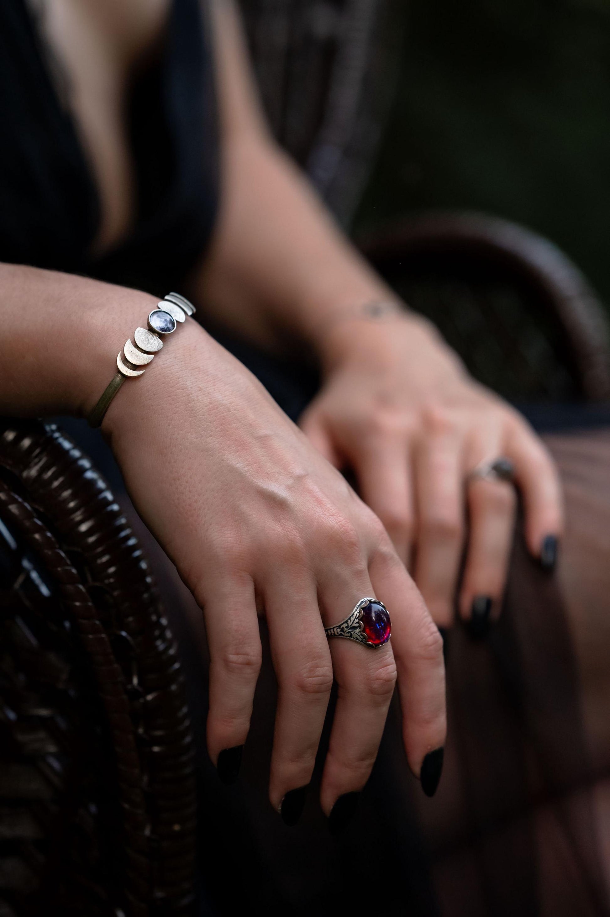 Close-up of hands with jewelry on a dark background