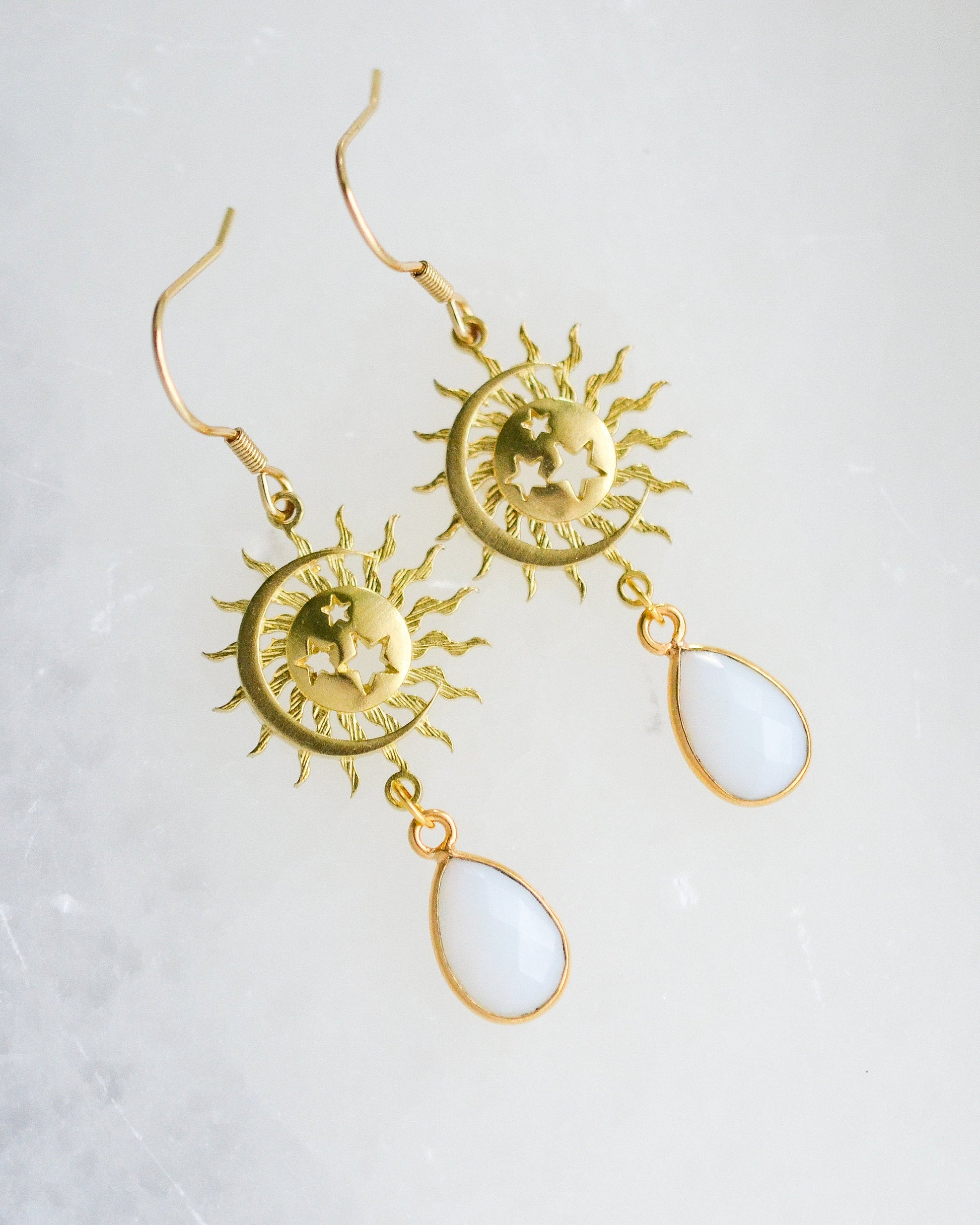 Brass sun moon and star  dangle earrings with pear shaped white iridescent stones