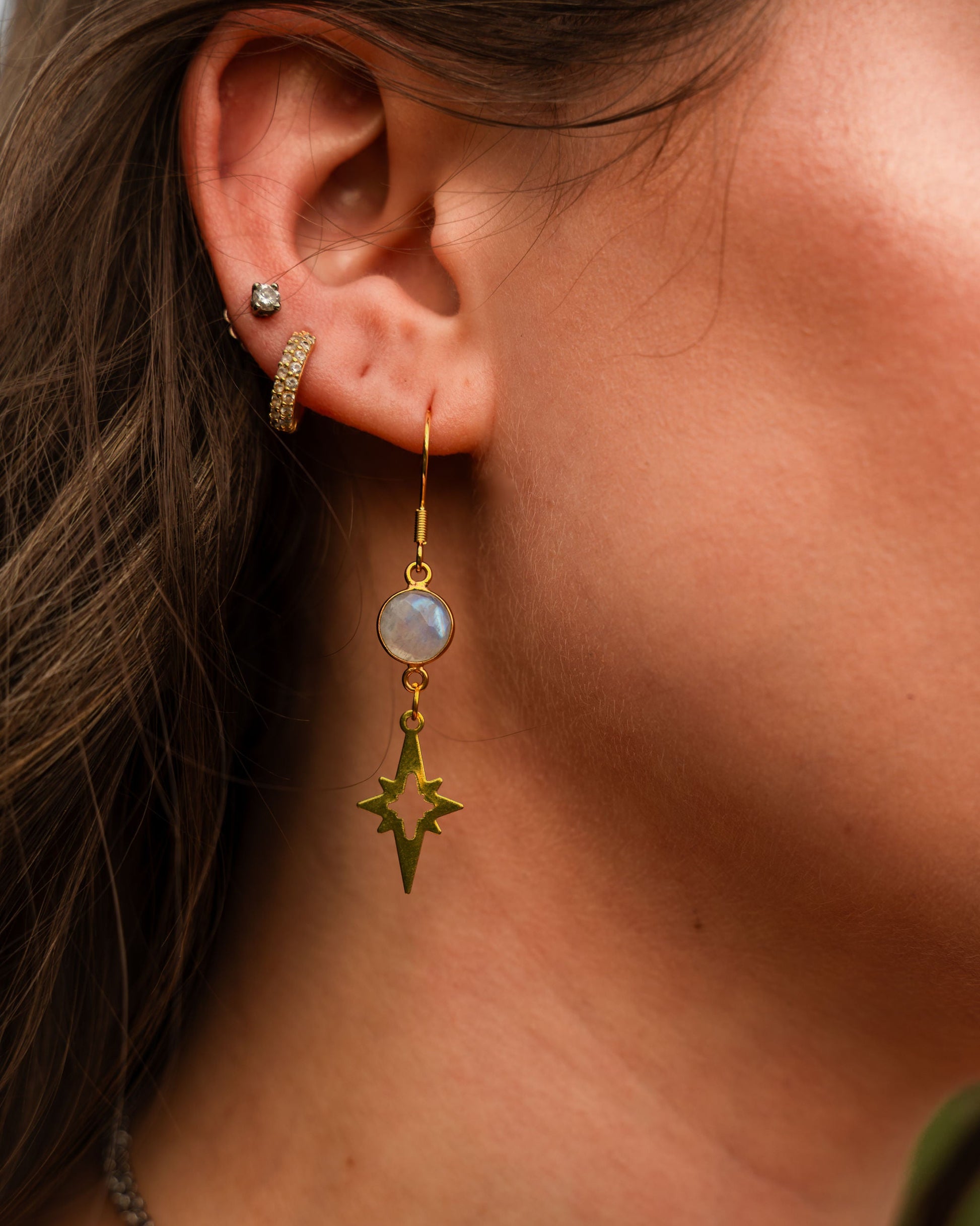 Dangle gemstone earring being worn with two other earrings