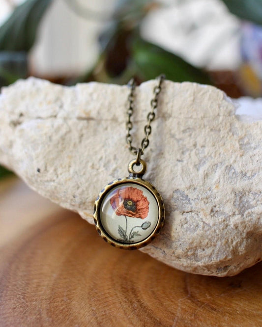 Necklace with a floral pendant on a rock