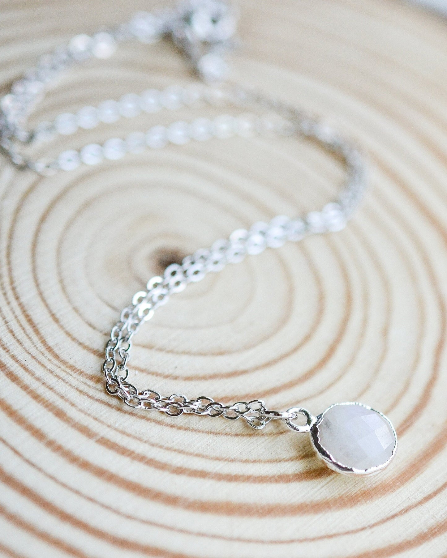 White crystal necklace on a wooden background