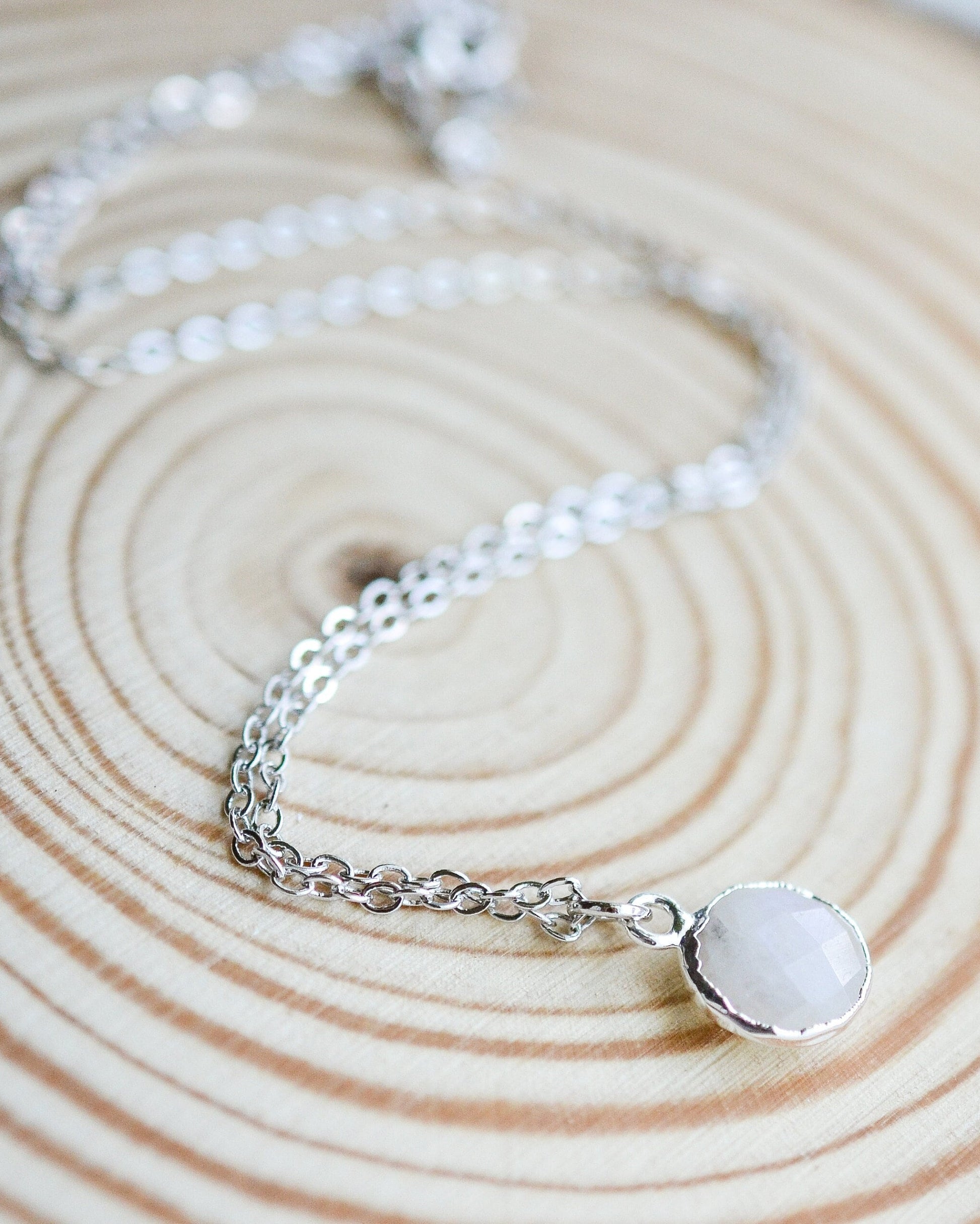 White crystal necklace on a wooden background